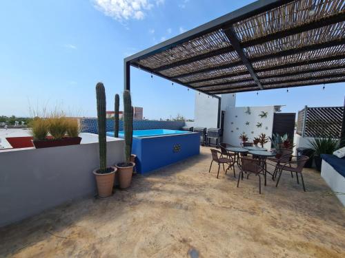 a patio with a table and chairs and a pool at TERRARIA APARTMENT NO 6 , NEW AND GREAT LOCATiON in La Paz