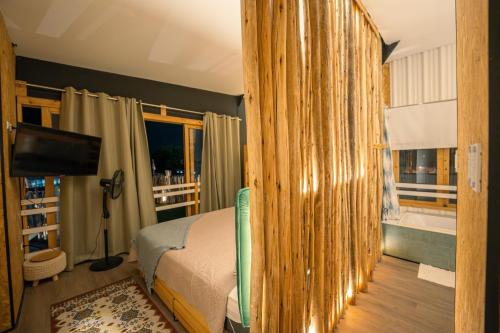 a bedroom with a bed and a television in a room at El Santuario in Paracas
