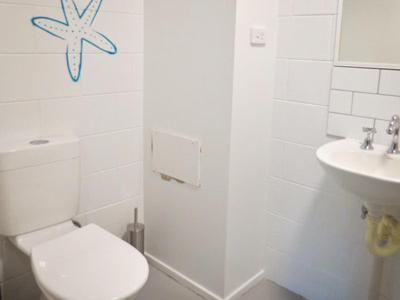 a bathroom with a toilet and a sink at Port Douglas Backpackers in Port Douglas