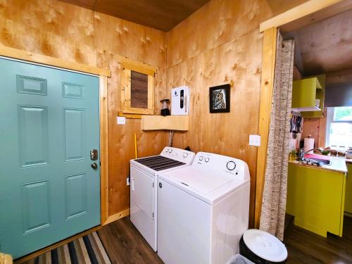 a washer and dryer in a kitchen with a door at Woodcrest Bed and Breakfast in Clearwater