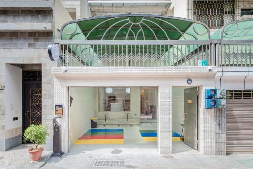 a building with a rainbow floor in front of it at Long Stay Here in Tainan