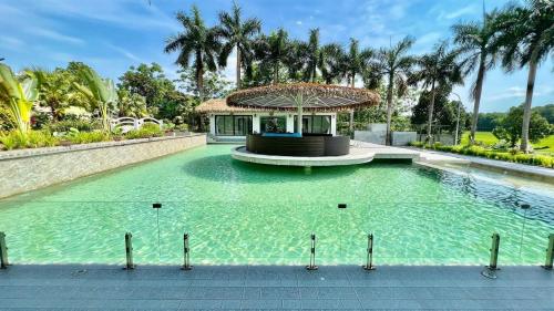 a swimming pool with a gazebo in the middle at Eagle Bavi Resort in Ba Vì