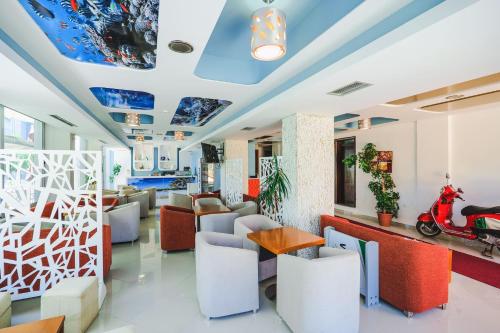 a lobby of a restaurant with a scooter on the ceiling at Summer Dream Hotel in Sarandë
