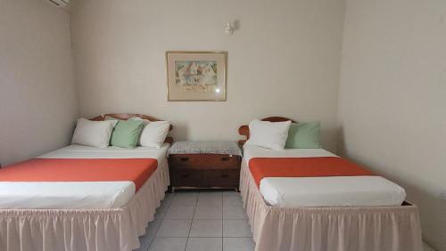 a room with two beds in a room at Casa Villa Apartments in Calliaqua