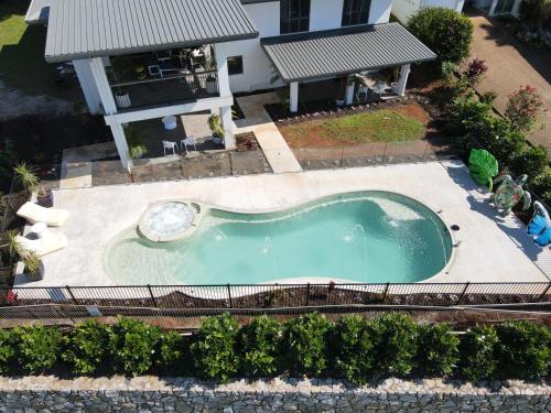 an overhead view of a swimming pool in front of a house at Forever Endeavour in Mission Beach