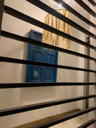 a window in a building with a blue shutter at Hotel Casa Lucca in Medellín