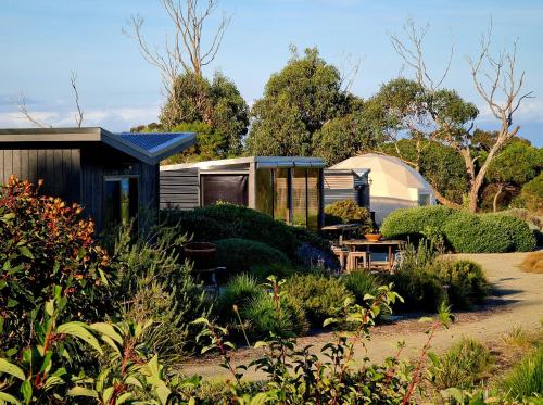 a tiny house in the middle of a garden at Inverloch Glamping in Inverloch