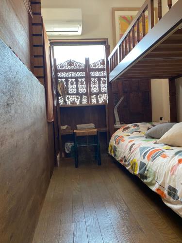 a bedroom with a bed and a stair case at Casa del girasolカサデルヒラソル in Moriguchi