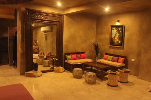 a living room with two couches and a mirror at THE BAREWITHIN HOUSE in Jaipur