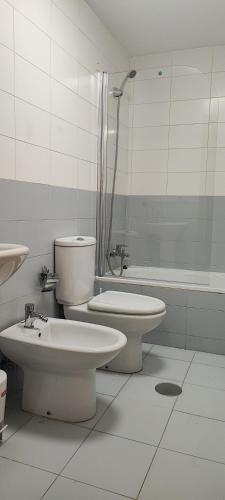 a bathroom with a toilet and a sink and a tub at La Figar,apartamento con piscina, playa a 3km VUT-4390-AS in Llanes