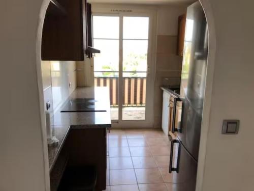 a kitchen with an archway leading to a large window at Très bel appartement Nice vue mer in Nice