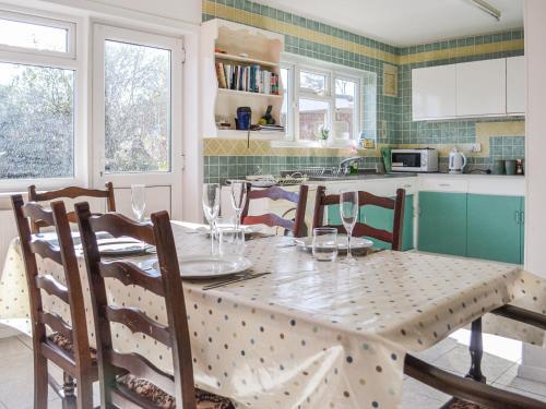 a kitchen with a table and chairs and a table and chairsktop at Botany Bay Bungalow in Kingsgate