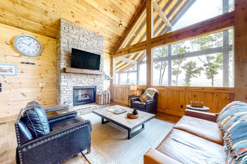 a living room with a fireplace and a clock on the wall at Liberty Call in Blue Ridge