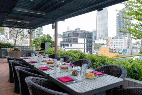 a long table with plates of food on top of a building at Sedona Suites Ho Chi Minh City in Ho Chi Minh City