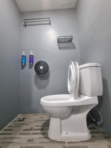 a bathroom with a toilet with the lid up at Met A Space Pod @Phrom Phong in Bangkok