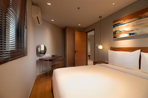 Cama o camas de una habitación en Beachwalk Residence
