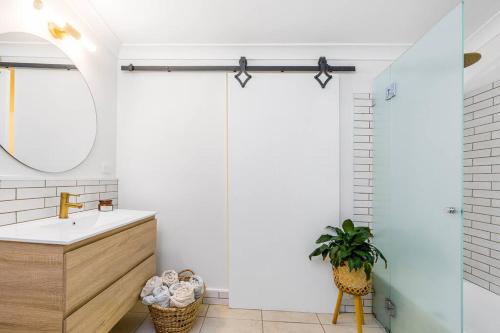 a bathroom with a sink and a mirror at Shirley Beach House, right in heart of Byron Bay, walking distance to town and most famous beaches, Pet Friendly in Byron Bay