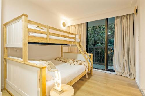 a bedroom with bunk beds and a balcony at The Rocks Resort Unit 4C in Gold Coast