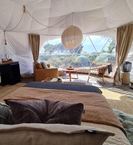 a bedroom with a bed and a large window at Inverloch Glamping in Inverloch