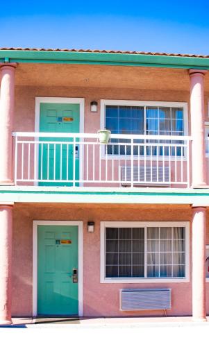a building with two doors and a balcony at Discovery Inn in Hayward