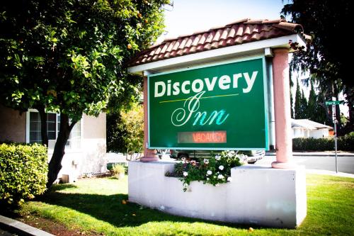 a sign for a disneyney inn in front of a house at Discovery Inn in Hayward