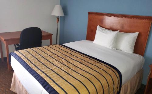 a hotel room with a bed with a desk and a chair at Coratel Inn & Suites by Jasper New Braunfels IH-35 EXT 189 in New Braunfels