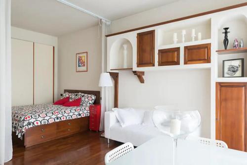 a bedroom with a bed and a white couch at Studio Downtown Fantastic Area in Milan