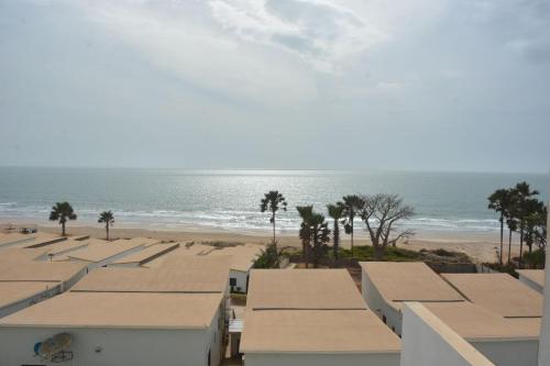 a view of the beach from the balcony of a building at Luxury & Comfort, with Pool and Ocean Views in Bijilo