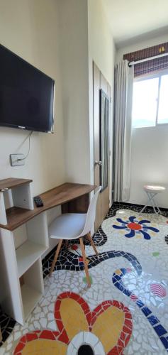 Uma televisão e/ou sistema de entretenimento em Ritacuba House Boutique
