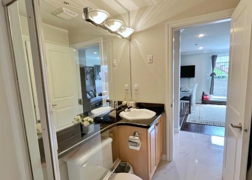 a bathroom with a sink and a mirror at Coze home in Vancouver near YVR in Vancouver