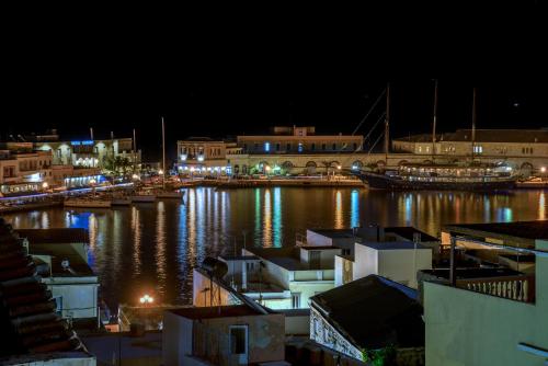 a harbor at night with boats in the water at Ethrion in Ermoupoli