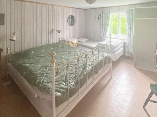 a bedroom with a bed with a cat sitting on it at 7 person holiday home in ÄLGARÅS-By Traum in Skagen