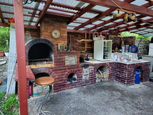 a brick oven with a table and a chair at Green Villa 
