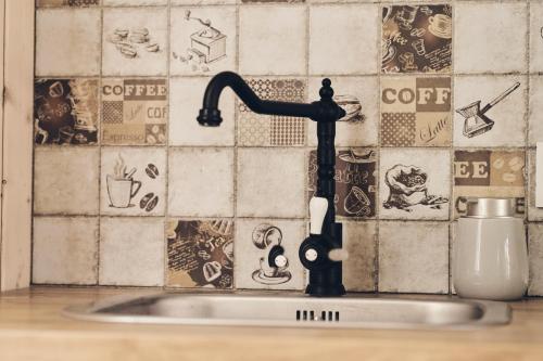 a sink with a faucet in a kitchen at Holiday Siesta Domki in Rewal