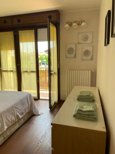 a bedroom with a bed and a table with towels at B&B Campi di sole in Sala Bolognese
