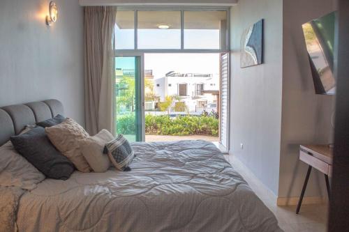 a bedroom with a bed with a large window at Private Villa in Gated Community Pet-Friendly in Cabo San Lucas