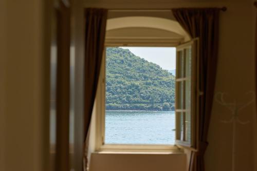 an open window with a view of the water at Vila Perast Boutique Hotel in Perast