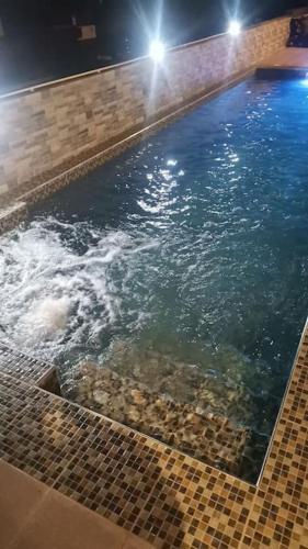 a large pool of water with rocks in it at Villa for rent in Albion