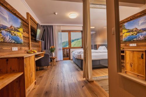 a hotel room with a bed and a window at Landhaus Ramsau in Ramsau am Dachstein