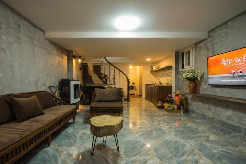 a living room with a couch and a tv at HIDDEN GEM*HEART of THE OLD QUARTER*5BR*FULL HOUSE in Hanoi