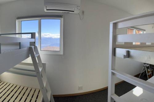 a room with two bunk beds and a window at Blueberry Apartment in Iiyama