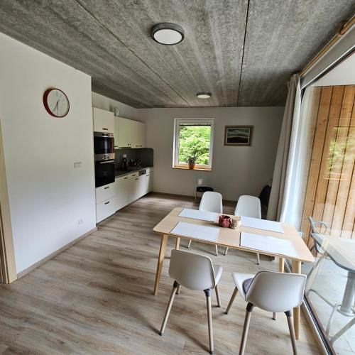 a kitchen and dining room with a table and chairs at Apartmány Pstruží AP19 in Pstruží