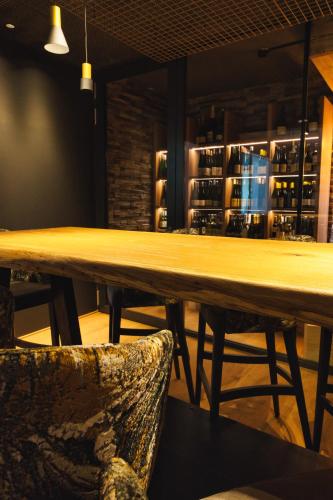 a large wooden table in a bar with a chair at Landhaus Ramsau in Ramsau am Dachstein