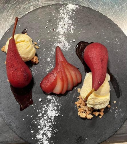 a plate with ice cream and fruit on it at The Black Lion Royal Hotel in Lampeter