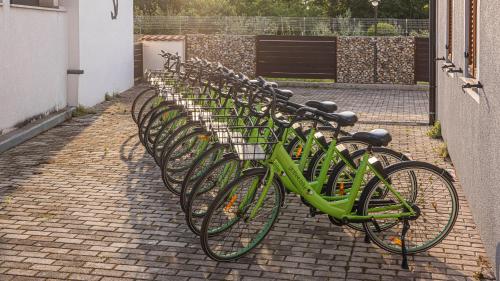 a row of green bikes parked next to a building at Val Piana in Savudrija