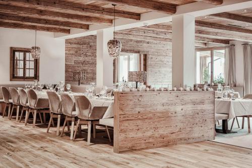 a dining room with a long table with chairs at Hotel St. Georg zum See in Maurach