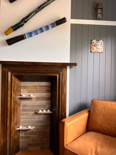 a room with a door with baseball bats on the wall at Sunflower House, a cozy cabin at Lake Wentworth in Wentworth Falls