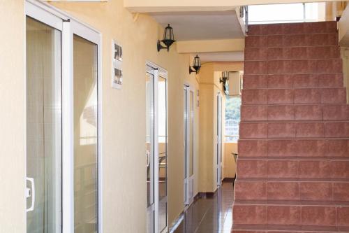 a stairway in a house with a glass door and stairs at Apartments and Studios Anicic in Utjeha