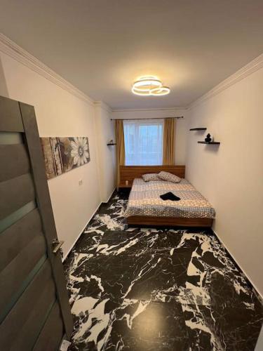 1 dormitorio con 1 cama en una habitación con suelo falso en Luxury Apartments by Patrik en Oradea