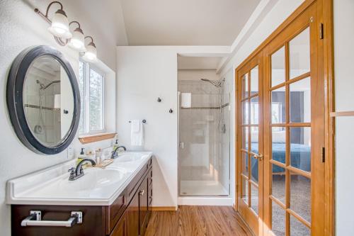 a bathroom with a sink and a mirror at Tanglewood Retreat in Post Falls